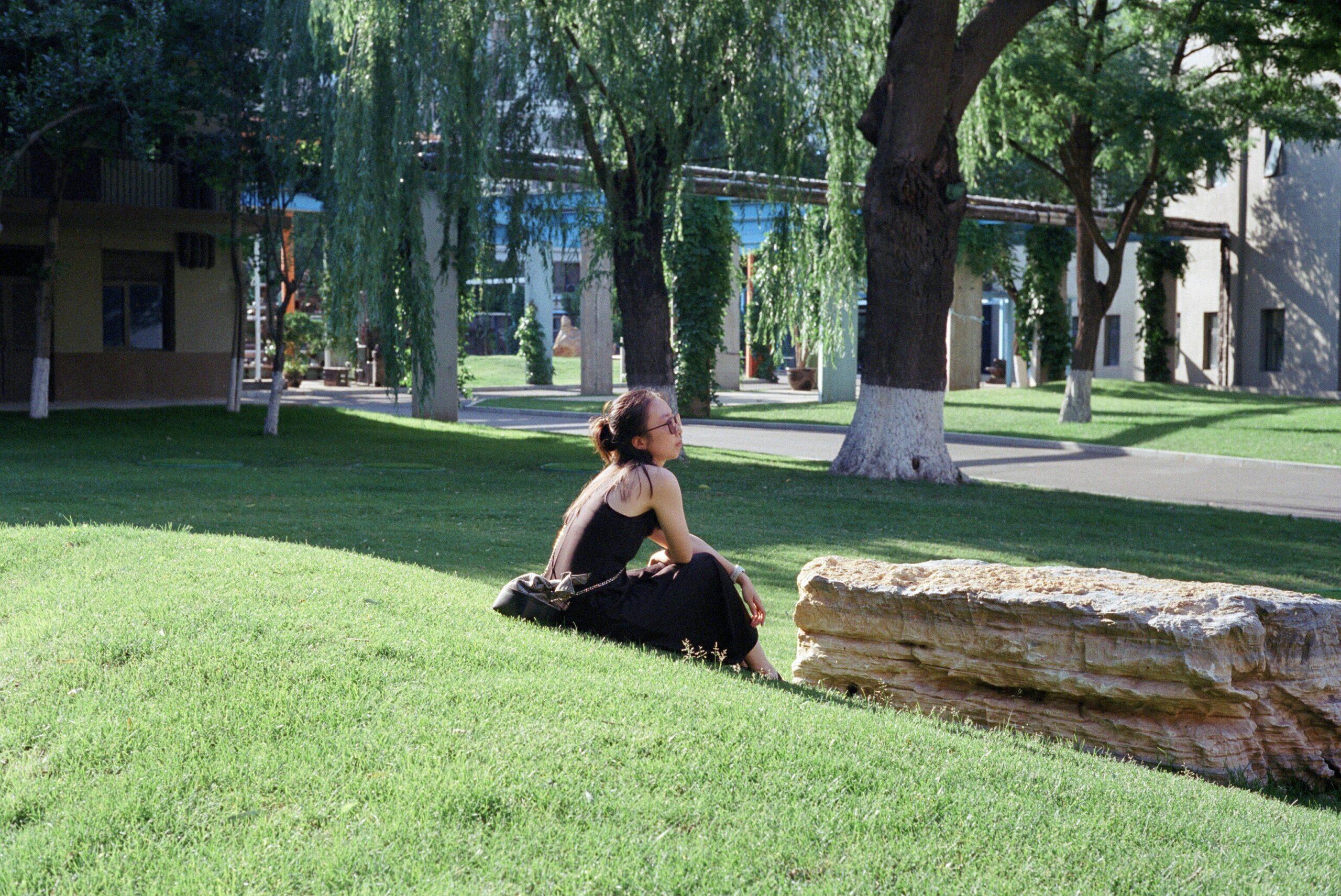A professional woman closing her eyes briefly for a quick meditation session in her office.