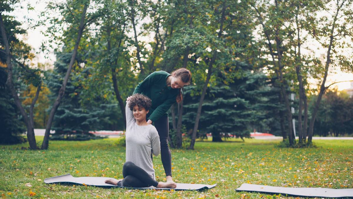 A person looking stressed while holding their phone with meditation apps open on screen.