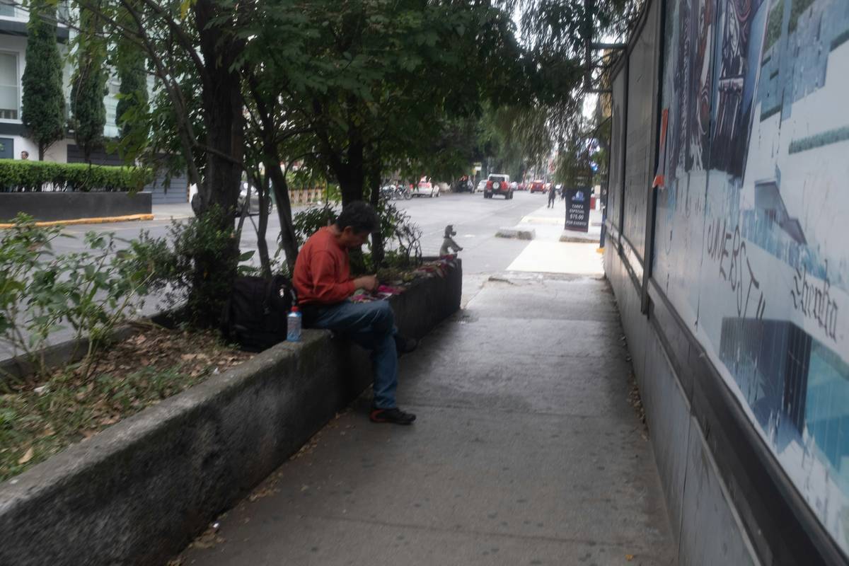 A smiling woman enjoying a peaceful moment while using her smartphone outdoors