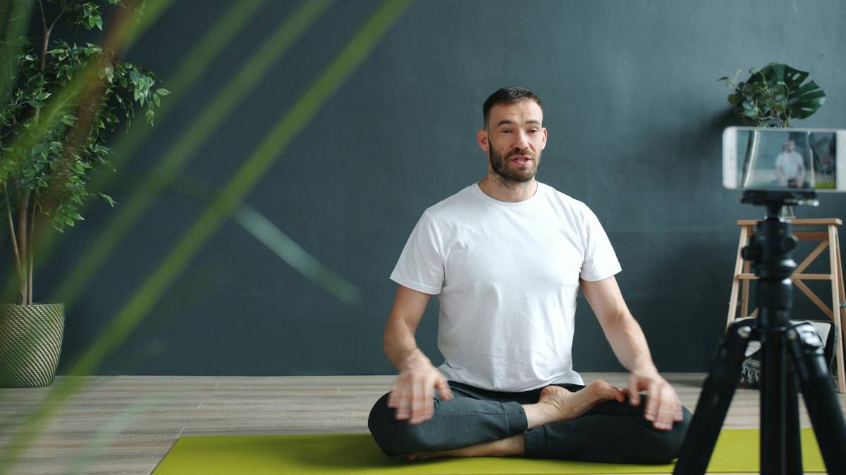 Photo of smiling woman sitting cross-legged practicing Buddhify meditation