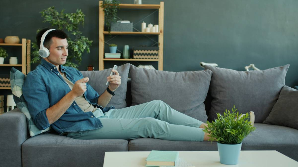 Photo showing someone looking stressed while holding a tablet and coffee cup