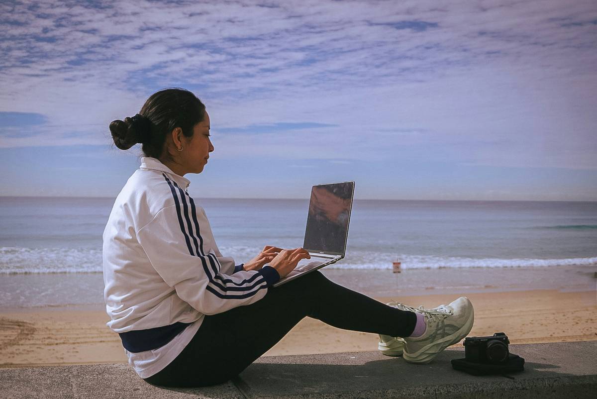 A person listening to Buddhify on their phone while relaxing outdoors